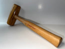 Wooden mallet with a visible brand name on a white background