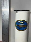 Jones surgical jar with a blue label and white container, shown next to a ruler for scale.