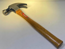Hammer with a wooden handle on a light gray background