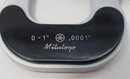 Close-up of a Mitutoyo measuring tool with measurement markings.
